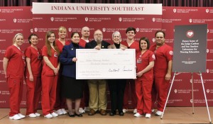 IU Southeast nursing students surround IU Southeast Chancellor Sandra R. Patterson-Randles (center left, in blue), Judge Carlton Sanders (center), and Interim Dean of the School of Nursing Jacquelyn Reid (center right, in tan) at the announcement of a $500,000 gift to the IU Southeast School of Nursing from Judge Carlton and Sue Sanders. The announcement was made Friday, March 15, at IU Southeast. 