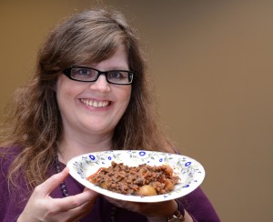 Dr. Jean Abshire, professor of political science at Indiana University Southeast, shows off a plate of her homemade lamb stew with prunes. Abshire made the stew as part of a "Hunger Games"-themed meal for students in her contemporary topics in political science seminar, which is focused on politics and conflict in the "Hunger Games" books. Photo by Renée Petrina/Institute for Learning and Teaching Excellence