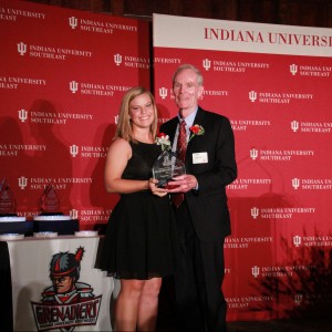 Summer Sanders accepts her award from Jim Morris. Sanders, a native of North Vernon, Ind., was a four-year starter and two-year captain for the Grenadiers. She helped lead the Grenadiers to four-straight KIAC regular-season championships and three-straight KIAC tournament championships from 2012-14. She was also a part of the first Grenadier softball team to advance to the NAIA Elite Eight in 2012. Sanders ranks No. 6 in career games played with 150. Her six career home runs are tied for No. 8 in school history. She is No. 8 in school history in both runs scored with 74 and RBI with 71. She ranks No. 10 in career at-bats with 311. Sanders was a 2014 NAIA Scholar Athlete and has earned recognition on the Athletic Director’s Honor Roll with a GPA of 3.0 in every semester of her collegiate career. She was on the Dean’s List four times. This season, she hit a walkoff grand slam against conference rival Asbury to end the first game of the doubleheader. In the second game of the day, she suffered a career-ending knee injury while attempting to catch a foul ball. Though her playing career had ended, she continued to lead the team and helped them win their fourth-straight KIAC regular season title during her career. She is majoring in Communications with a concentration in advertising. 
