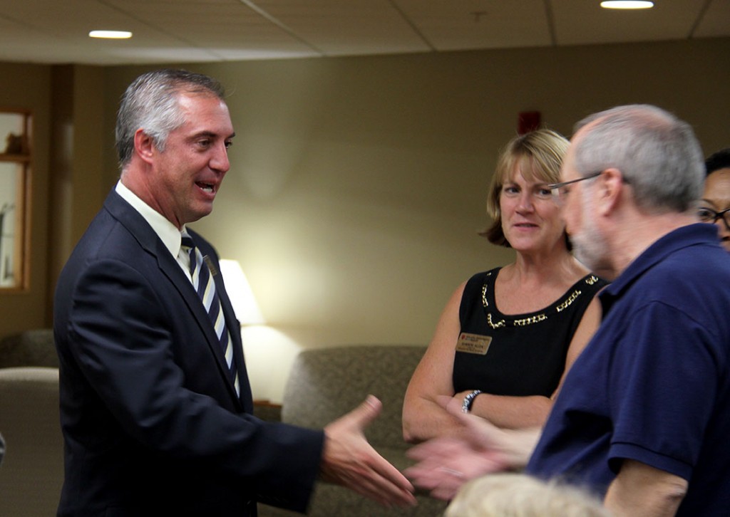J.T. Thomas (left) greets members of the IU Southeast faculty and staff.