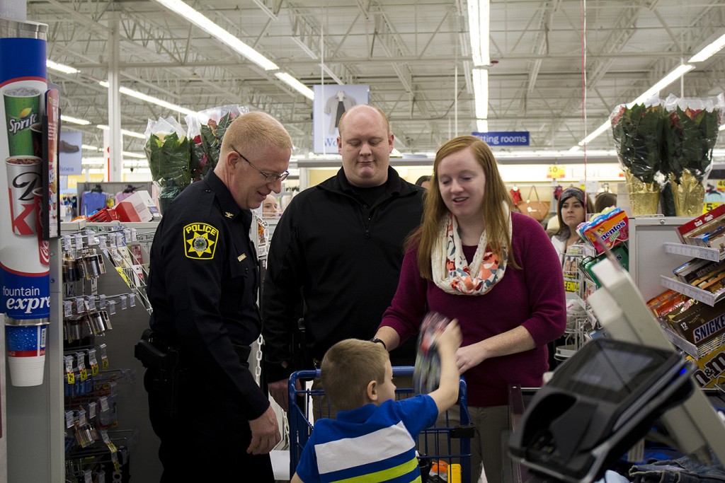 IU Southeast Chief of Police Charlie Edelen (left) shops with a family during Shop With a Cop at Meijer.