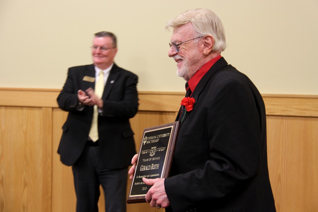 Dr. Gerald Ruth (right) smiles as he receives applause for 50 years of service to IU Southeast.