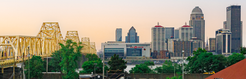 The Louisville, Kentucky cityscape with a yellow bridge in the foreground.