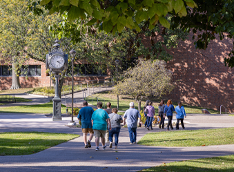 A group of prospective students and their parents touring a college campus.