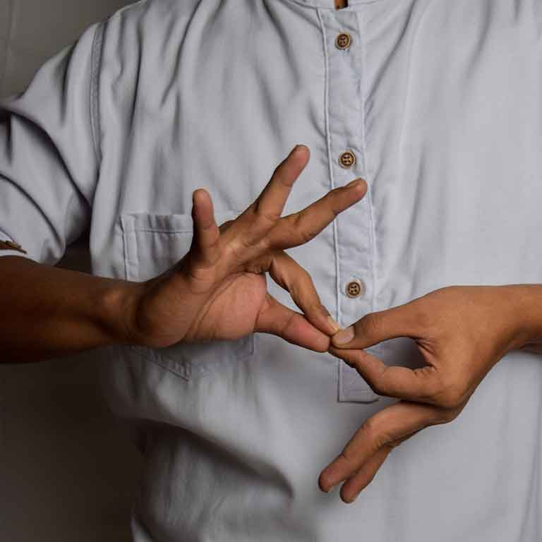 Person signing the word "interpreter" in ASL.