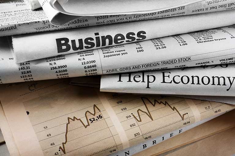 A stack of newspapers on the business section