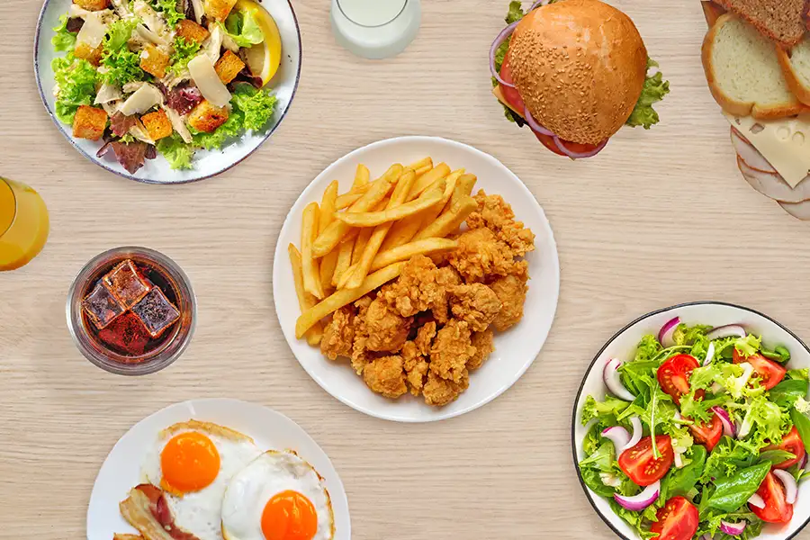 Burger and fries on a table with a beige background