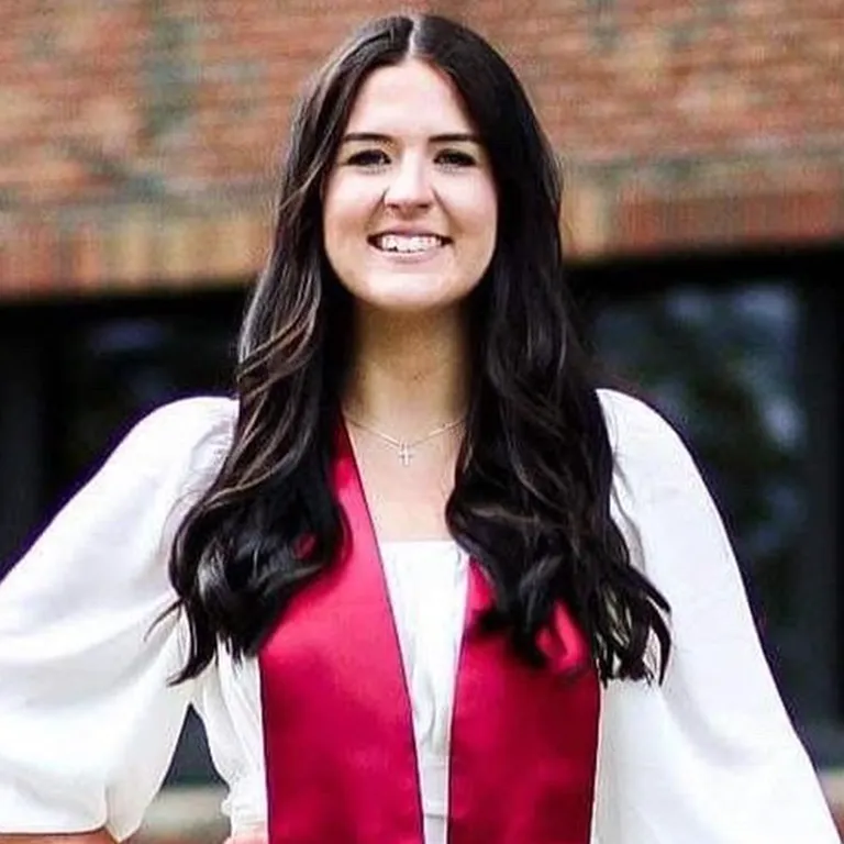 IU Southeast Honors Program student Breanna Doss posing in graduation stole and smiling