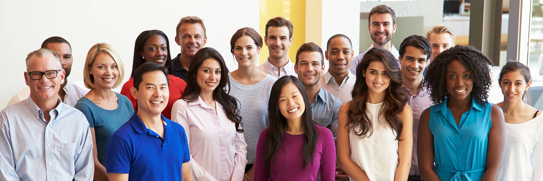 Diverse group of people posing for a group photo.