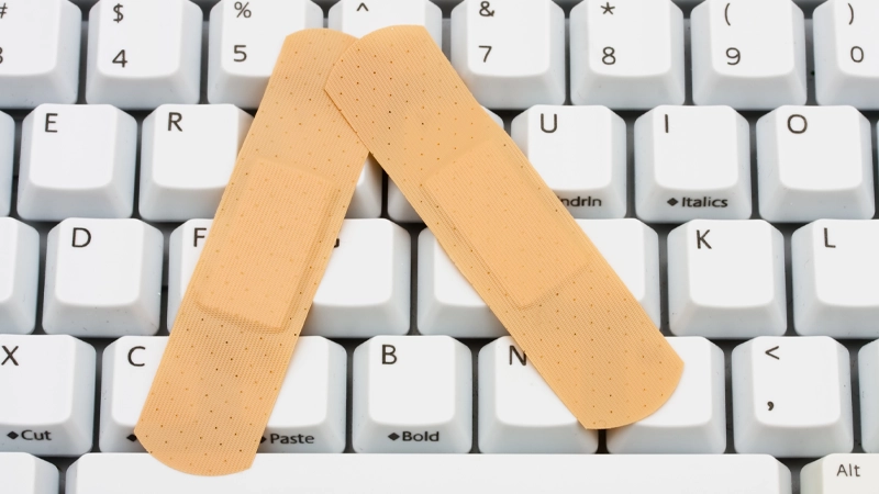 Hands typing away on a laptop computer.