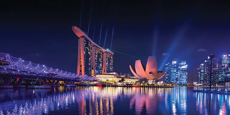 Singapore skyline at night reflected in the water