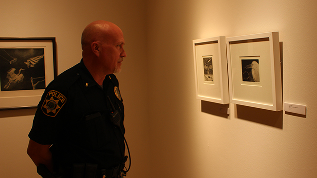 Lt. Stephen Miller looks at prints by Deborah Maris Lader