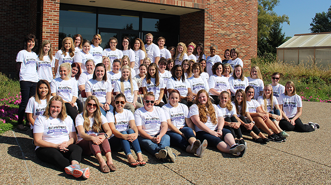Nursing students, faculty and staff in front of School of Nursing