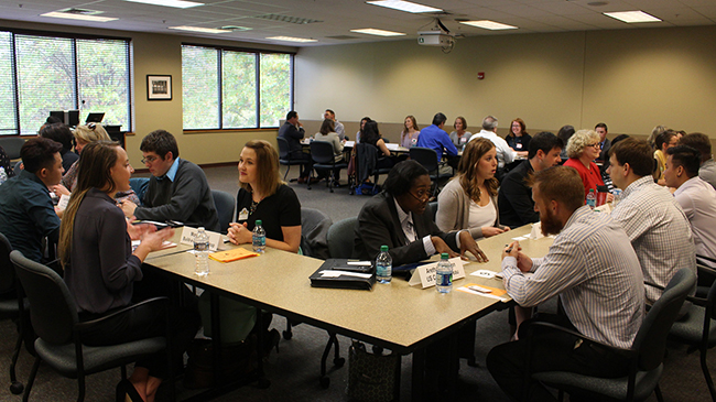 Employers and students interact at speed-networking event.