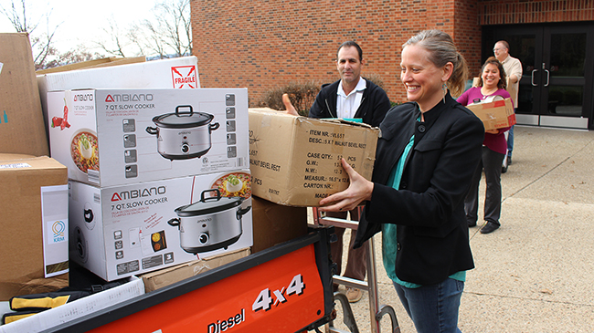Dr. Kelly Ryan, dean of the School of Social Sciences, helps load up donations for Kentucky Refugee Ministries.