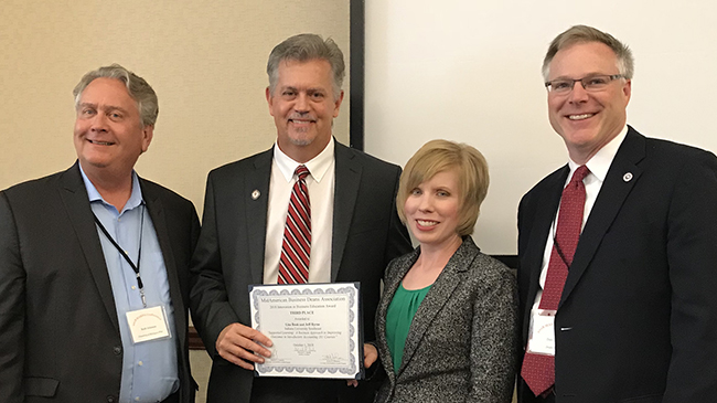 Dr. Scott Johnson, dean of the School of Management at the University of Michigan-Flint (l) and Dr. Daniel Connolly, dean of the College of Business and Public Administration at Drake University (r) present the MABDA Innovation in Business Education award to Dr. Jeffrey Byrne and Dr. Lisa Book, lecturers in accounting.