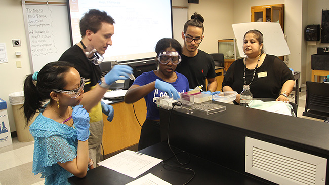 Dr. Suparna Mukhapadhyay (r) supervises first-year students learning to master basic lab techniques. Mukhopadhyay's commitment to innovation is coupled with a dedication to fundamental skills.