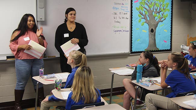 IU Southeast students Ericia Henry and Breanna Seabolt discuss bullying with middle school girls in New Albany, Ind..