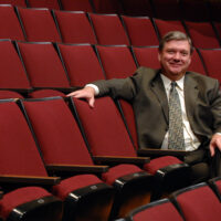 Former Director of the Paul W Ogle Cultural and Community Center, Kyle Ridout, relaxes in Stem Performance Hall seating.