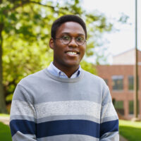 Christian Scott wearing a grey striped sweater pictured on the IU Southeast campus