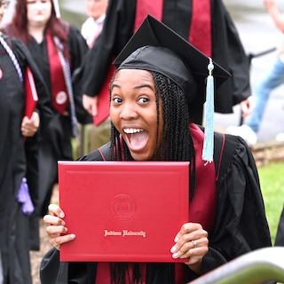 A graduate shows her joy after her name was called.