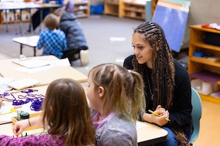 An IU Southeast student teacher works with Community Montessori children.