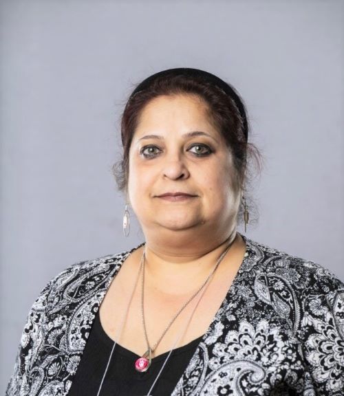 Dr. Suparna Mukhopadhyay in front of a grey backdrop