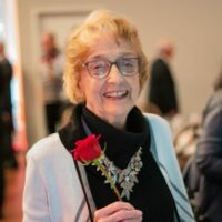 Older lady holding a rose